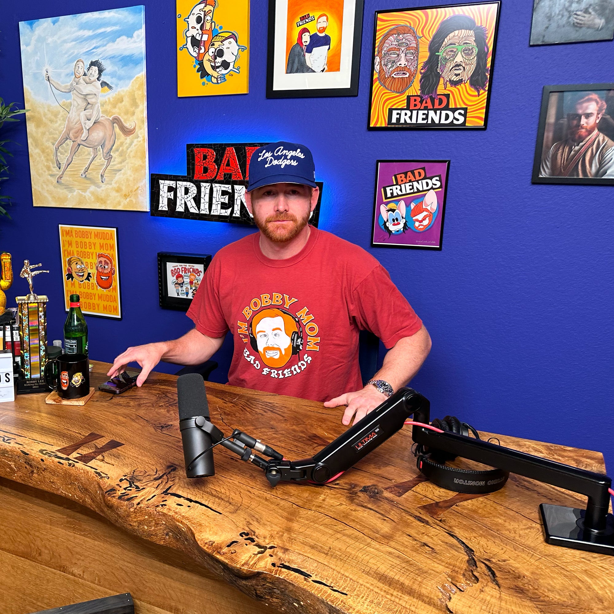 Andrew with his "I'm Bobby Mom" t-shirt sitting at his podcast chair