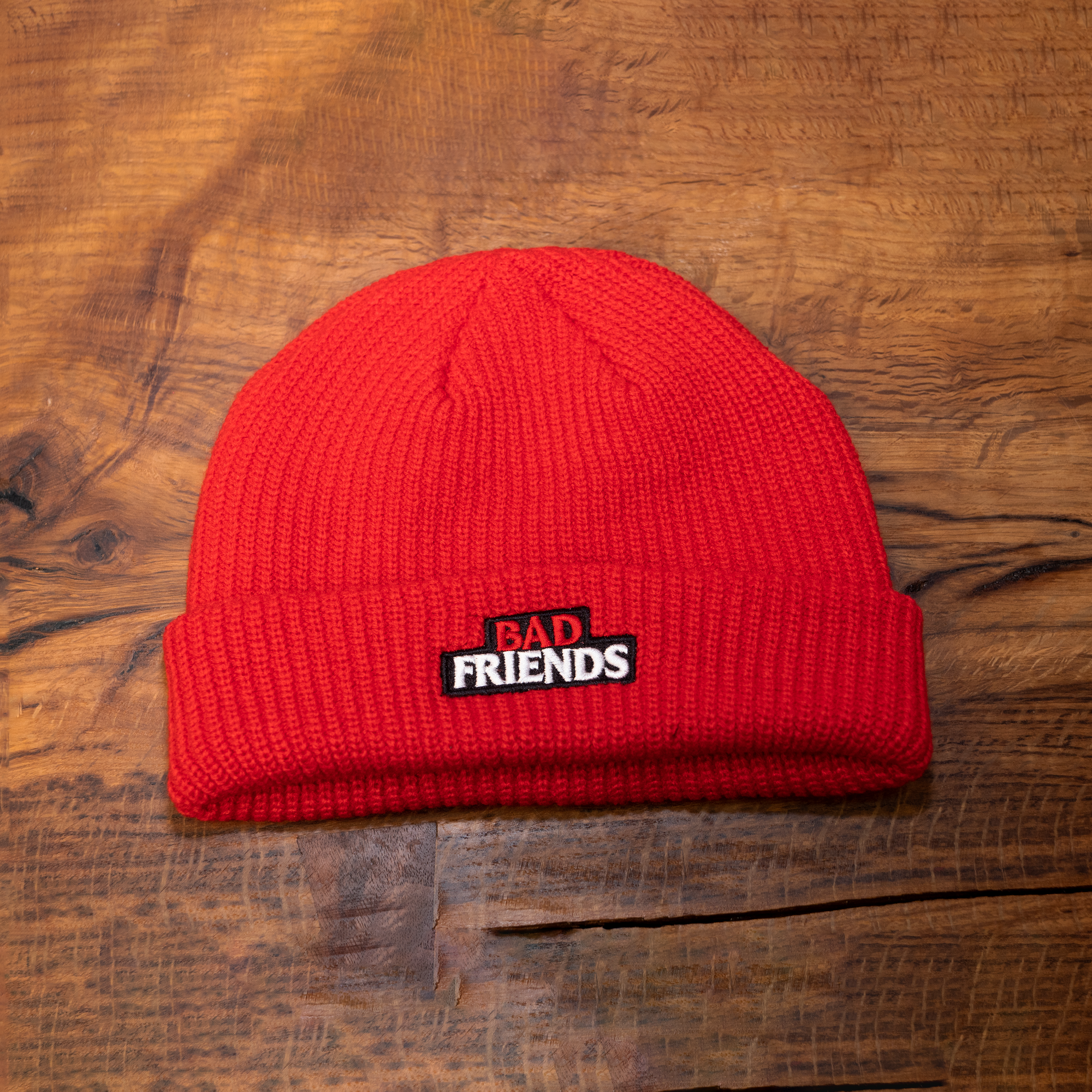 Close up red bad friends beanie